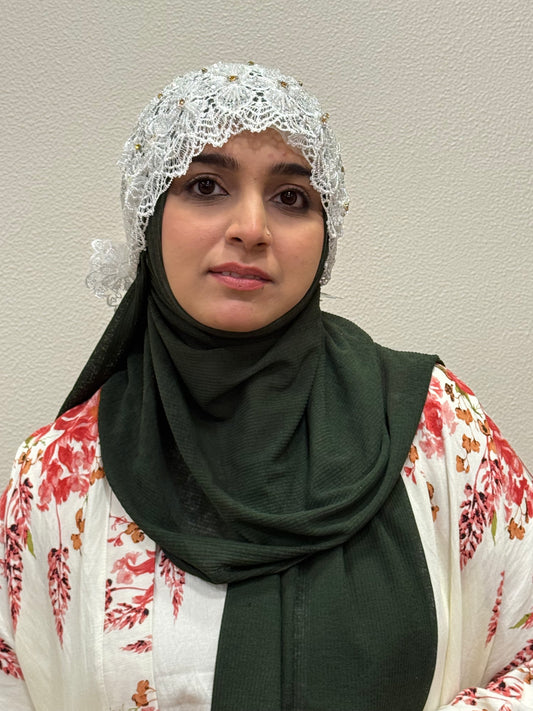 White embroidered hijab cap close-up front view with floral detailing