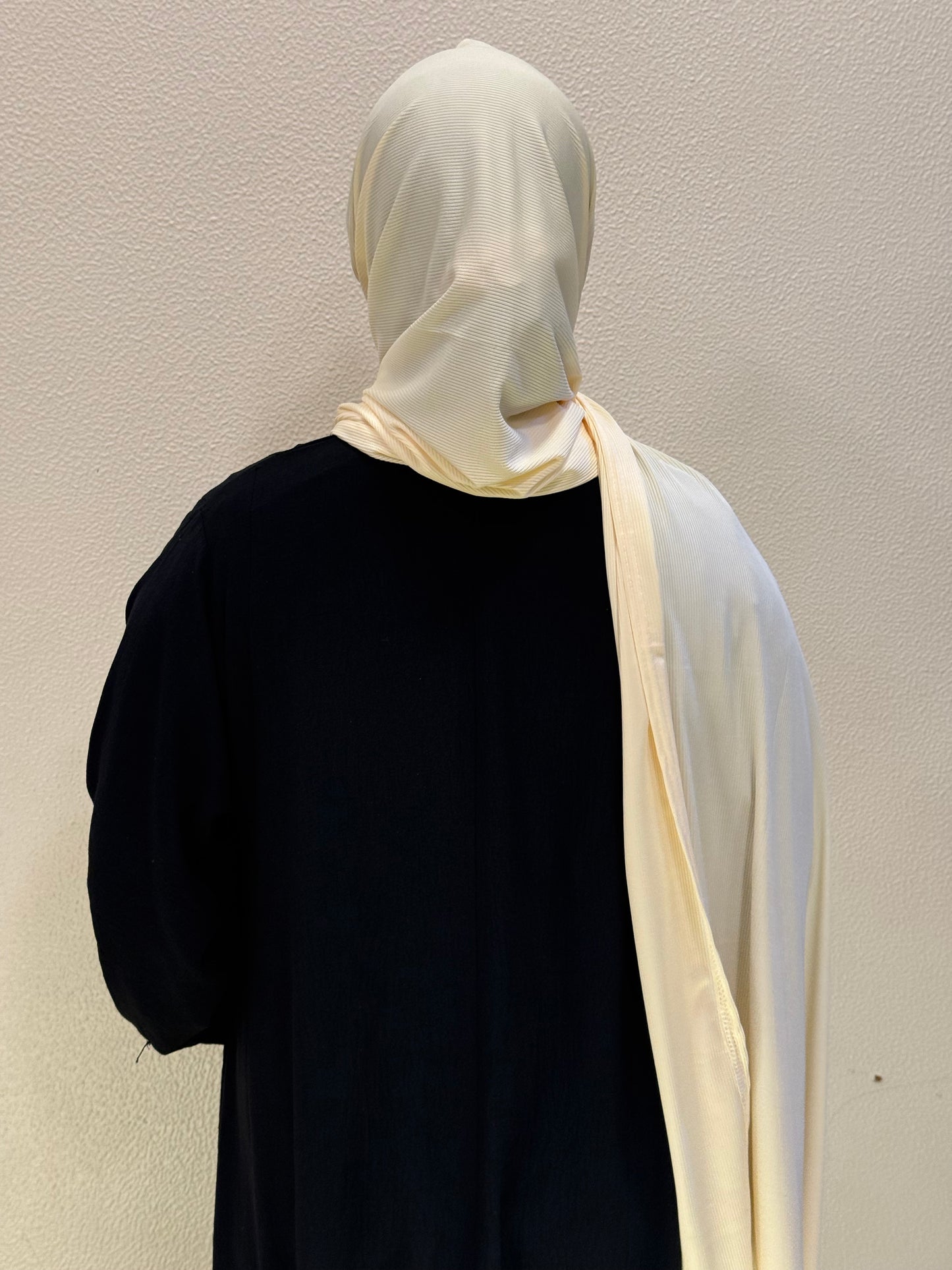 Back view of cream yellow jersey hijab showcasing long flowing design and versatile modest styling.