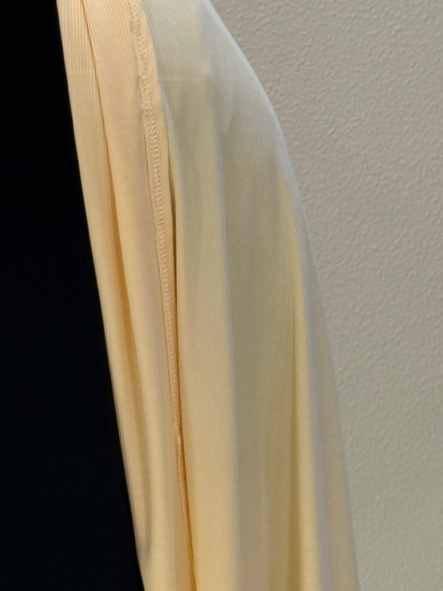 Close-up of premium mustard jersey hijab fabric showcasing fine ribbed texture and high-quality breathable material.