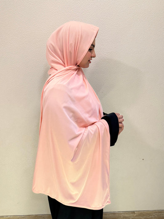 Front and side view of peach pink premium jersey hijab showcasing full coverage, lightweight comfort, and versatile everyday styling.