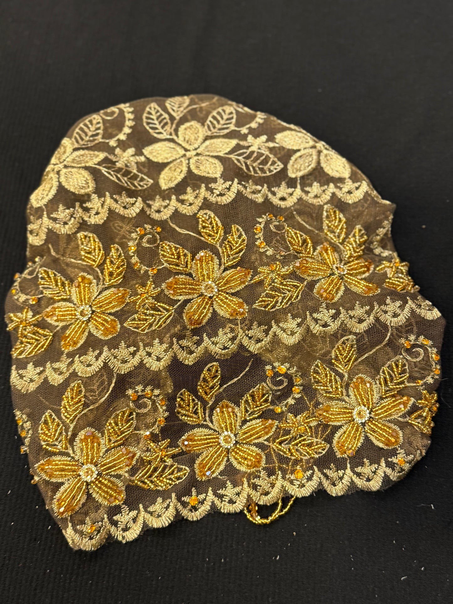 Gold lace hijab cap flat lay with embellished floral pattern