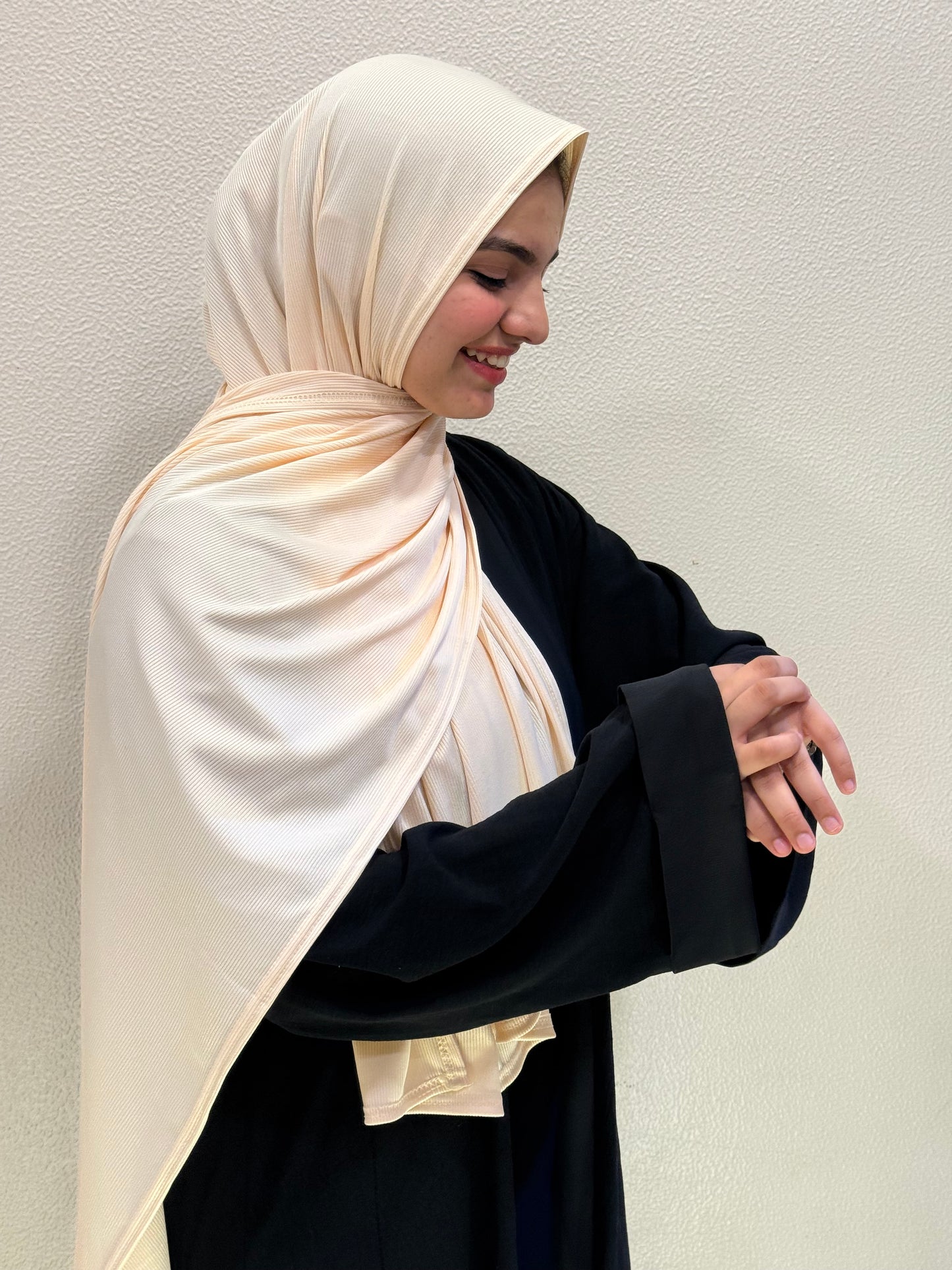 Close-up of cream jersey hijab highlighting smooth premium material, fine ribbed detailing, and graceful flow.