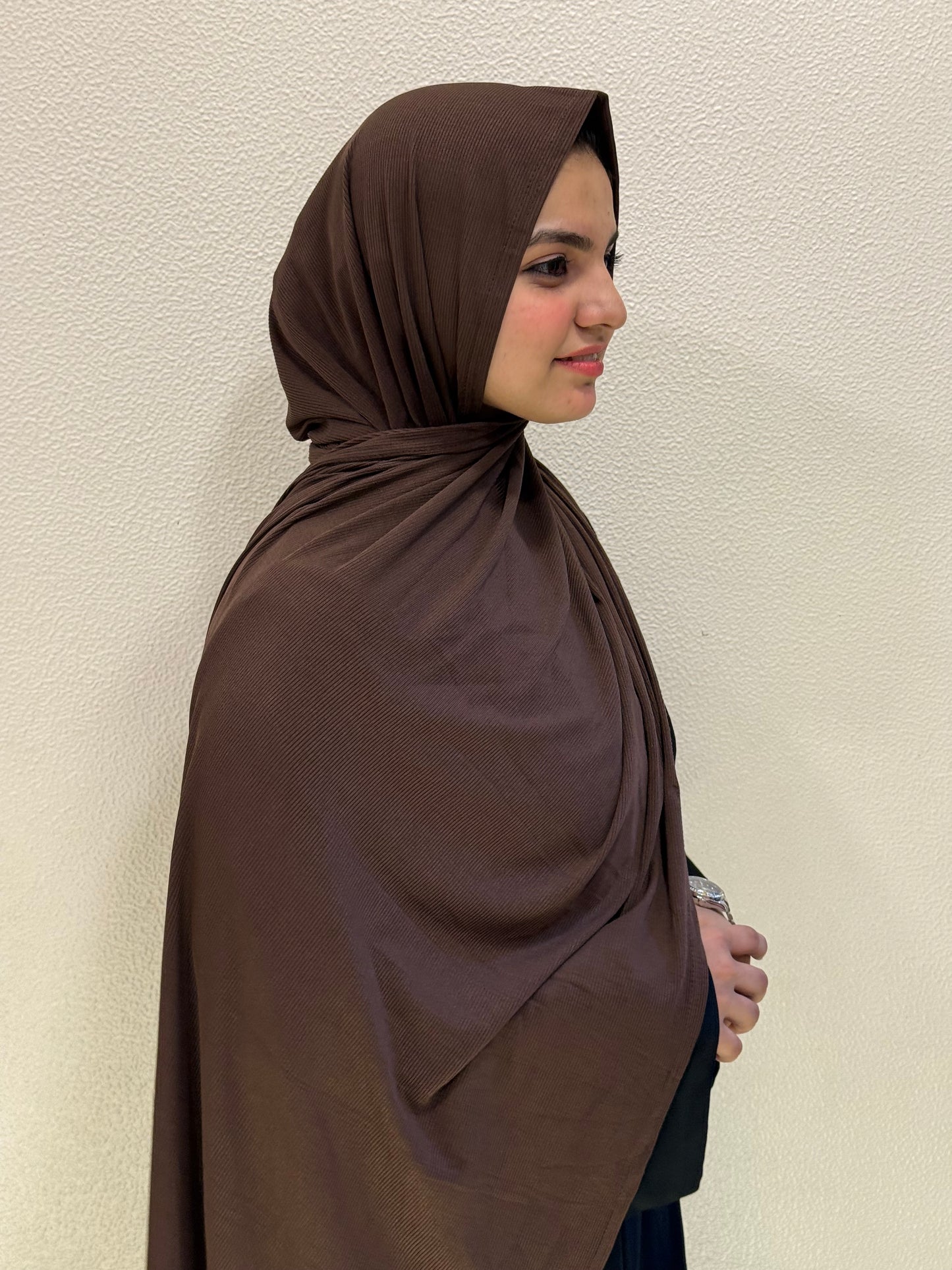 Smooth chocolate brown jersey hijab with premium material and graceful flow, ideal for casual, office, or formal outfits.