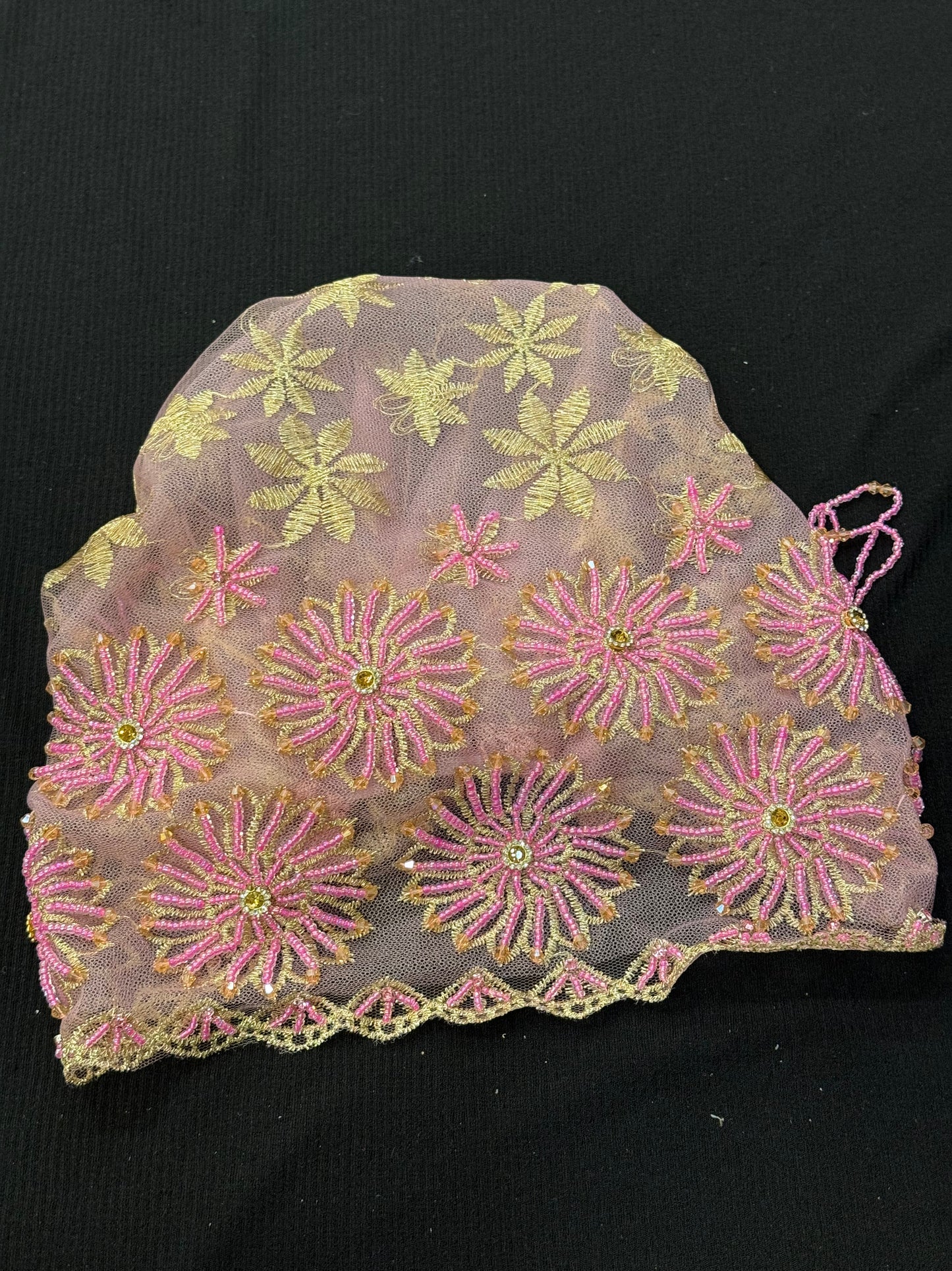 Pink and gold lace hijab cap flat lay with embellished floral pattern