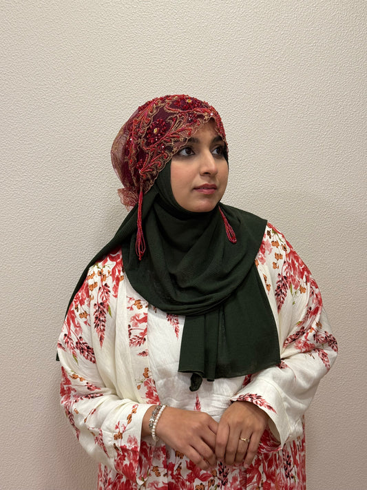 Red embroidered hijab cap close-up front view with beadwork