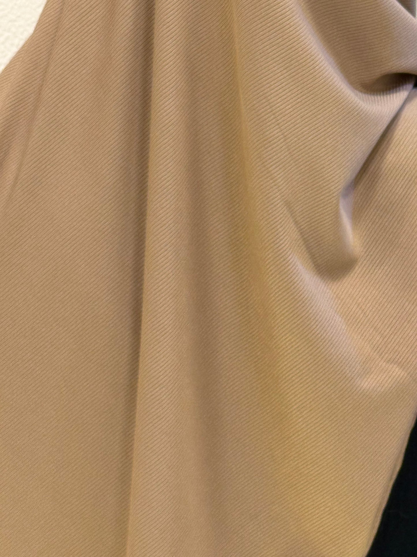 Premium jersey hijab close-up showcasing smooth stretch fabric in camel brown