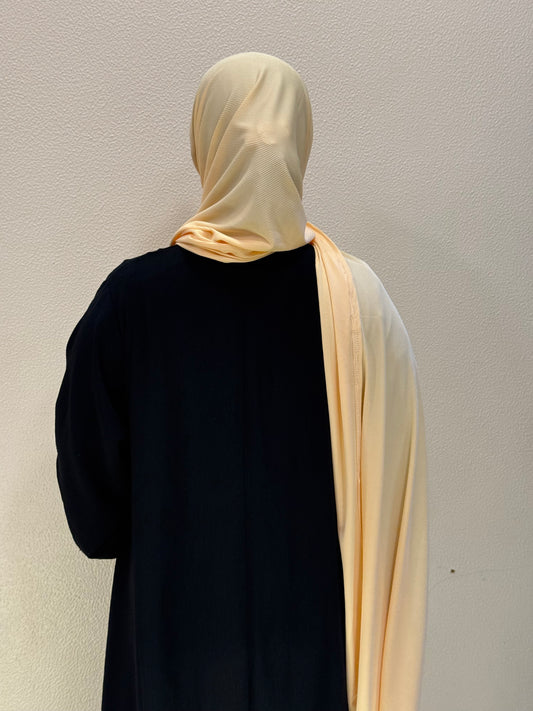 Front and back view of mustard yellow jersey hijab featuring smooth drape, full coverage, and versatile styling.