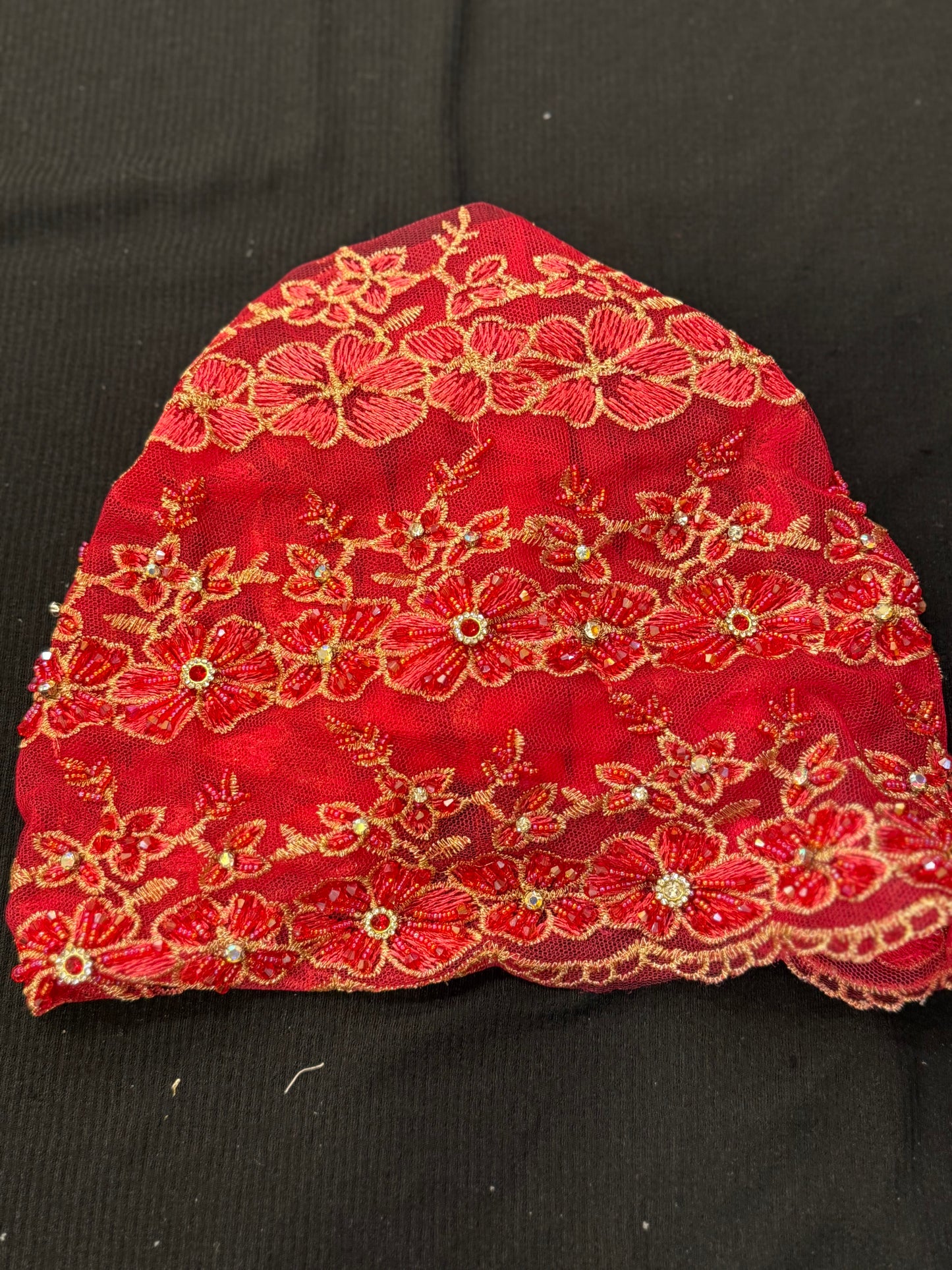 Red lace hijab cap flat lay with floral embroidery and embellishments
