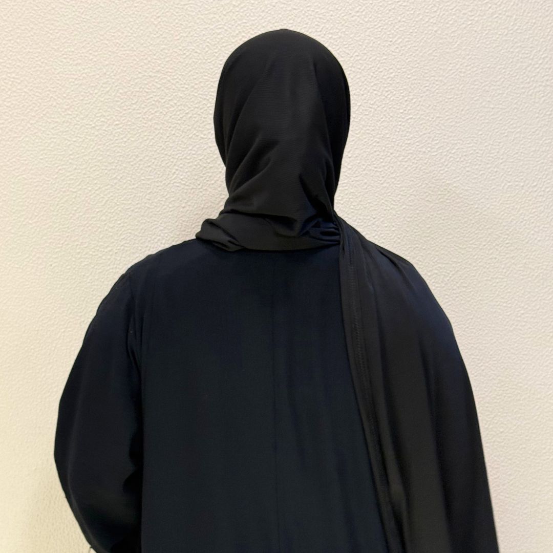 Back view of Premium jersey black hijab with soft breathable fabric, smooth drape, and elegant full coverage for everyday modest fashion.