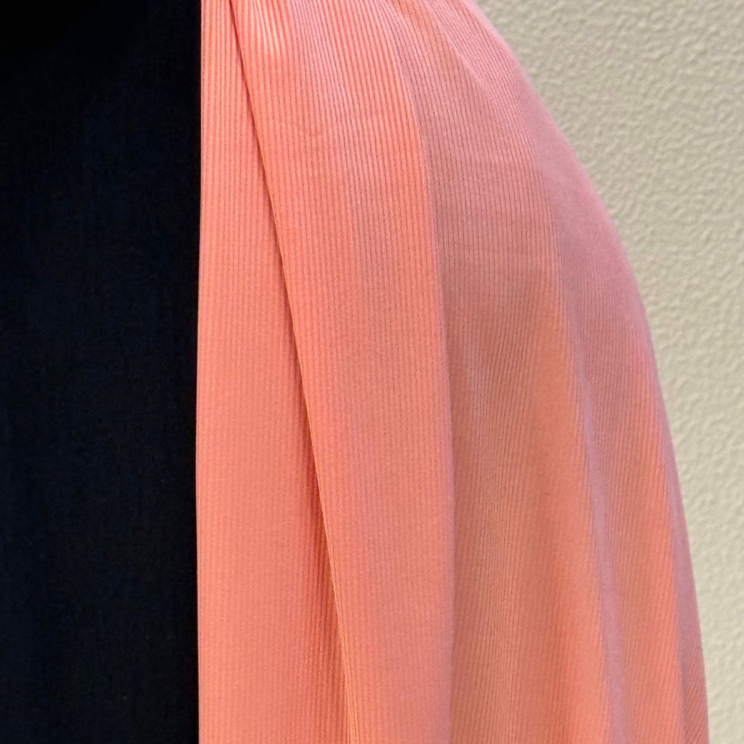 Smooth blush pink jersey hijab with premium material, fine ribbed detailing, and graceful flow for casual or formal outfits.