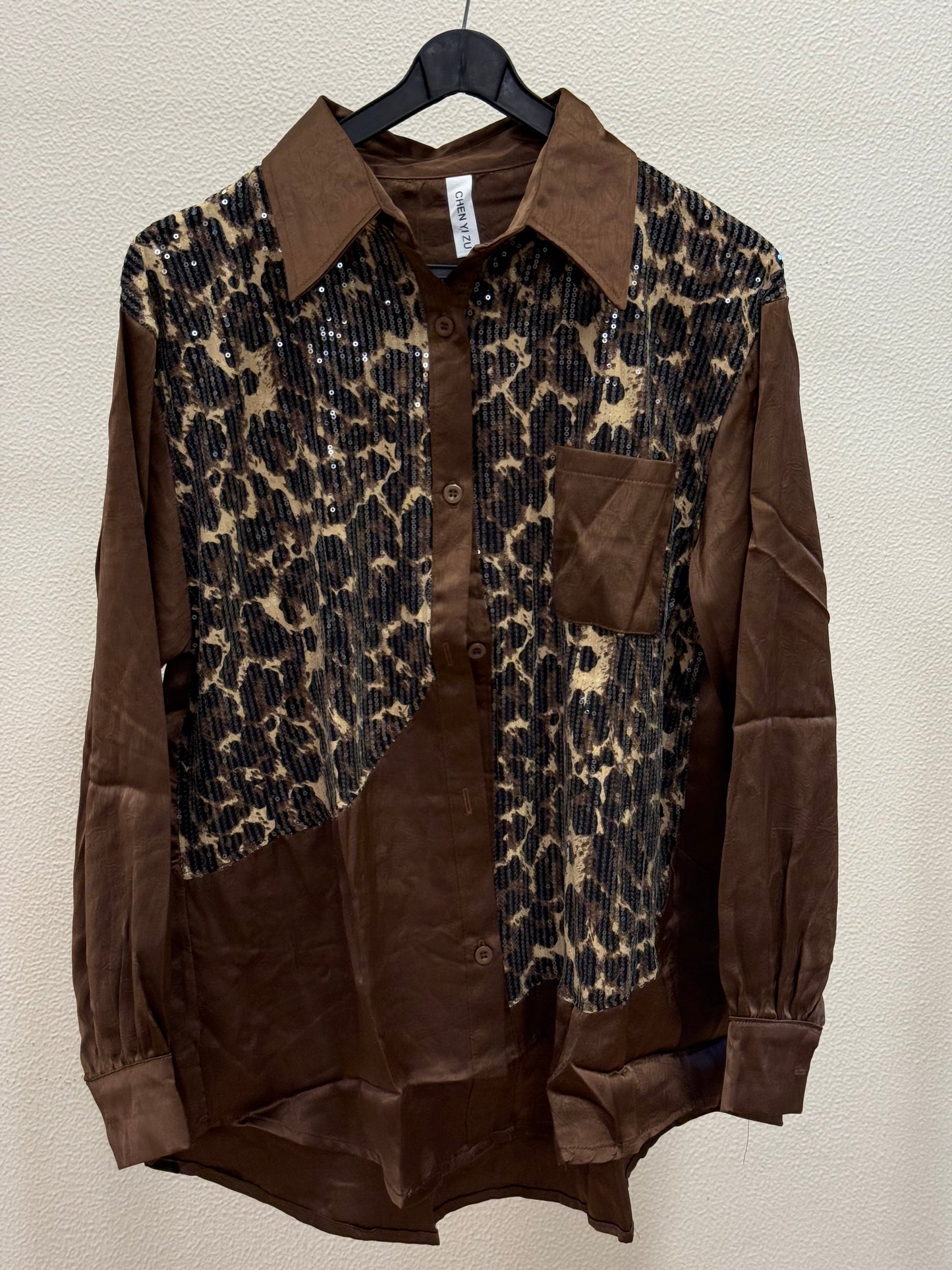 Brown satin shirt with sequin leopard print panel and chest pocket on hanger