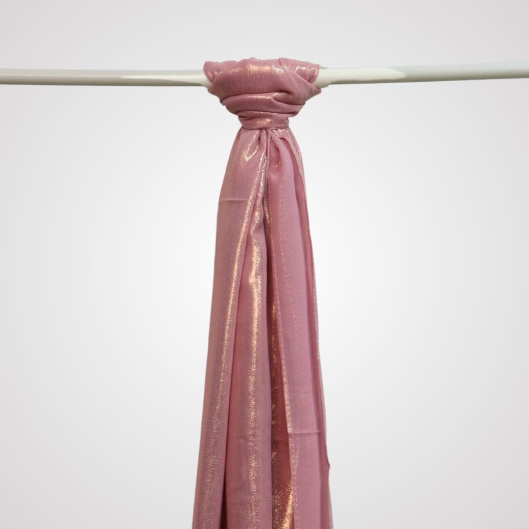 pink shimmer satin hijab on display hanger
