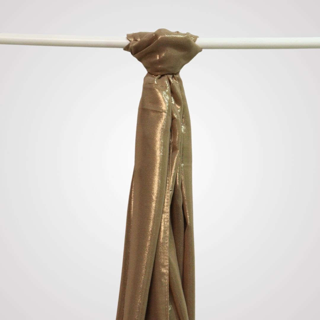 Gold shimmer satin hijab on display hanger