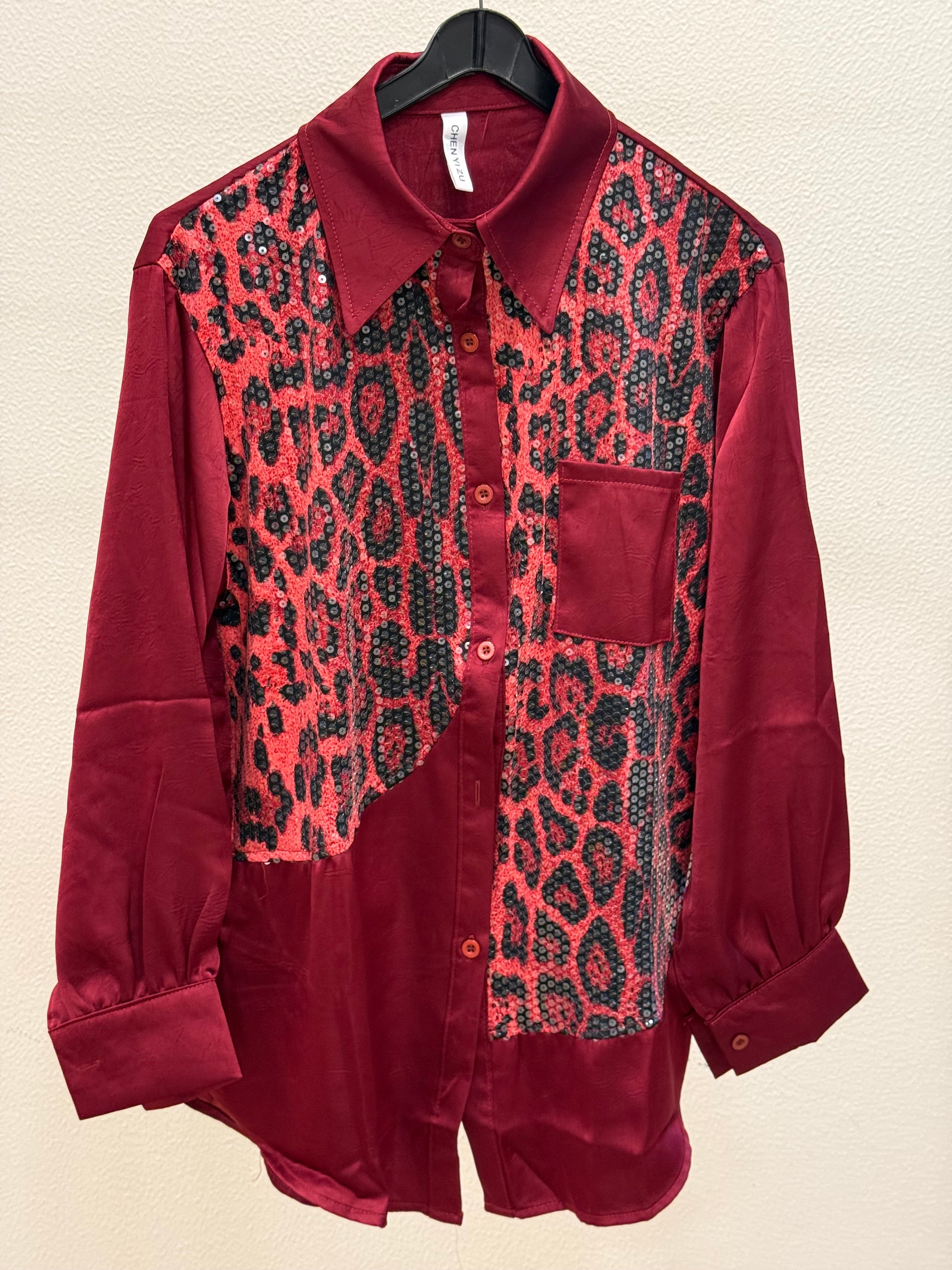 Red satin shirt with sequin leopard print panel and chest pocket on hanger