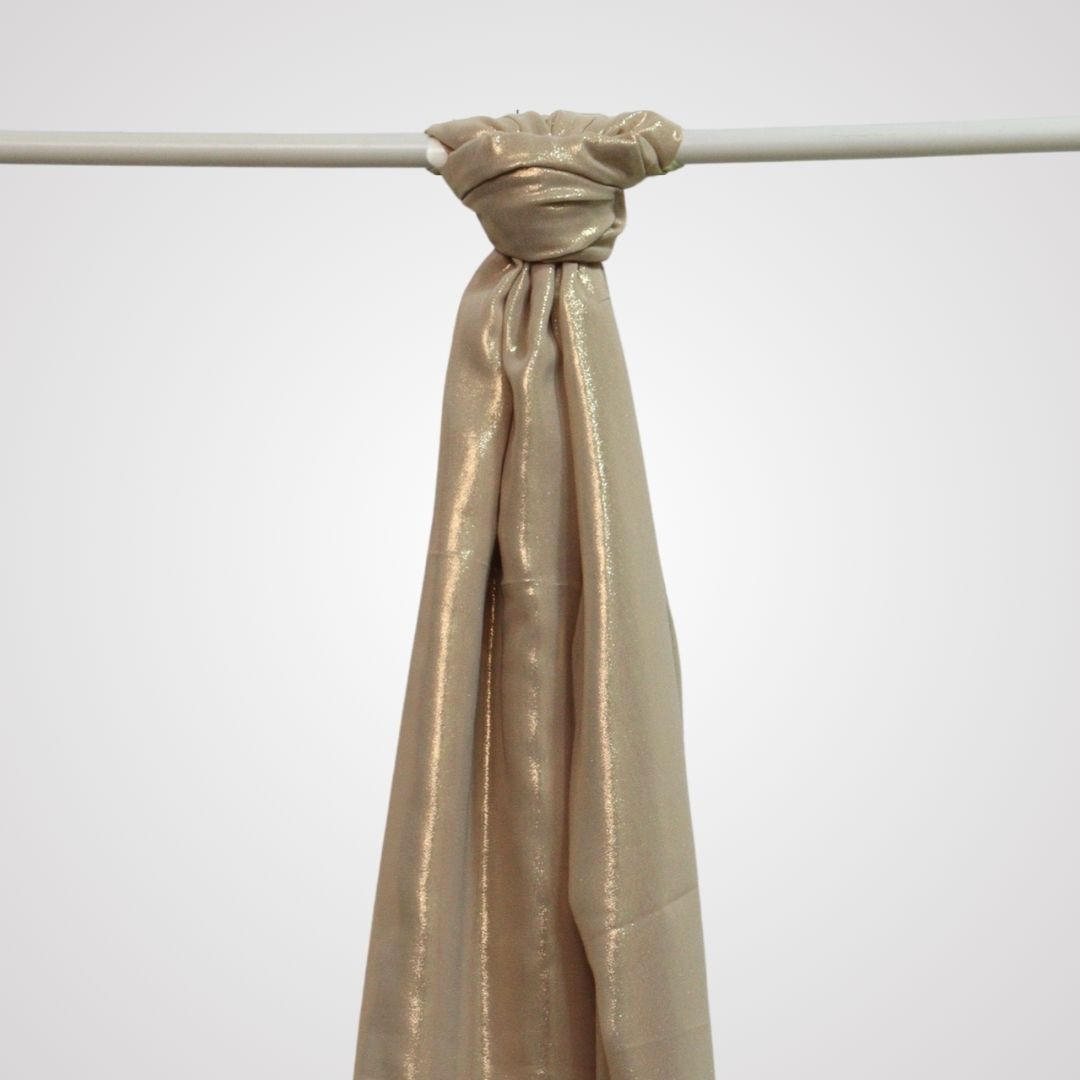 Gold shimmer satin hijab on display hanger