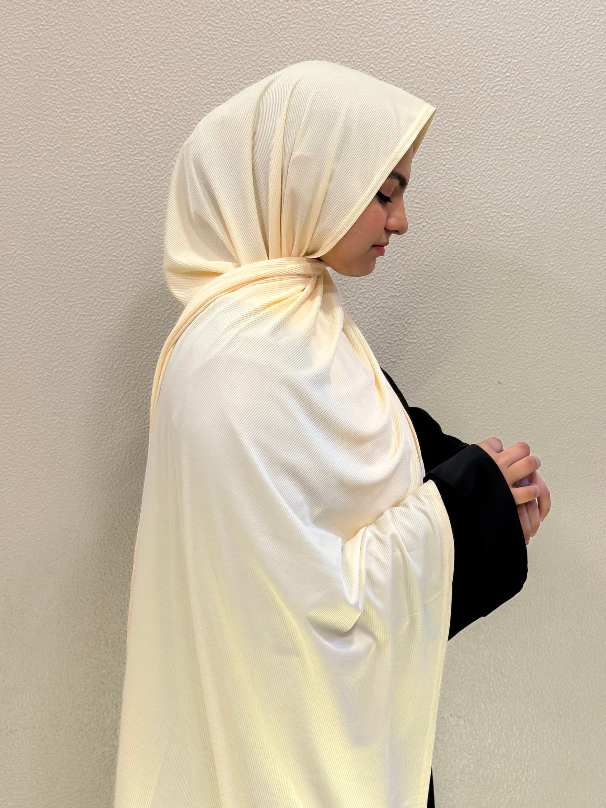 Premium jersey light yellow hijab with soft ribbed texture, styled elegantly for everyday modest wear.