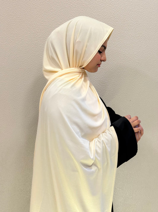 Premium jersey light yellow hijab with soft ribbed texture, styled elegantly for everyday modest wear.