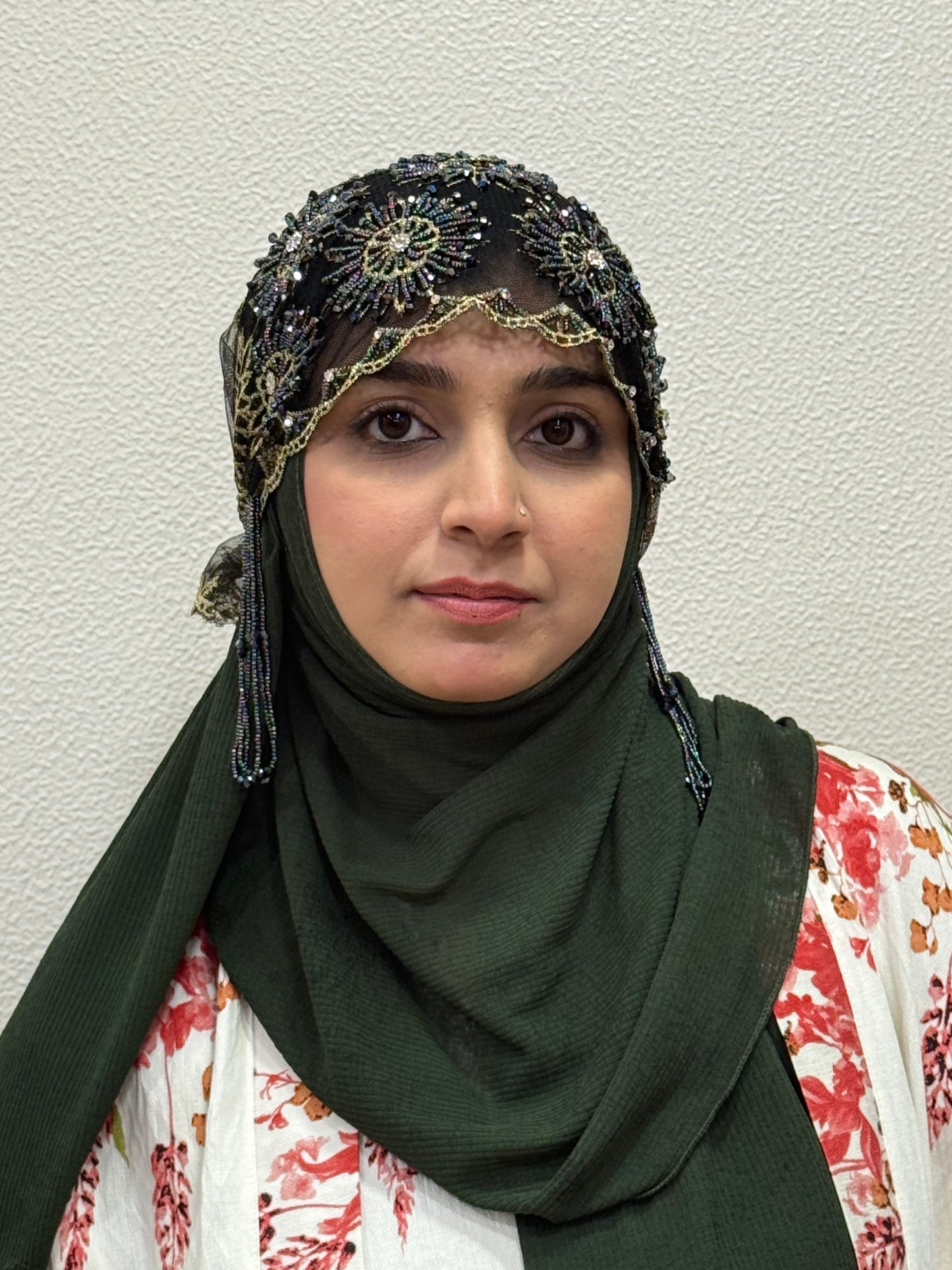Elegant black and gold embellished hijab cap front view close-up