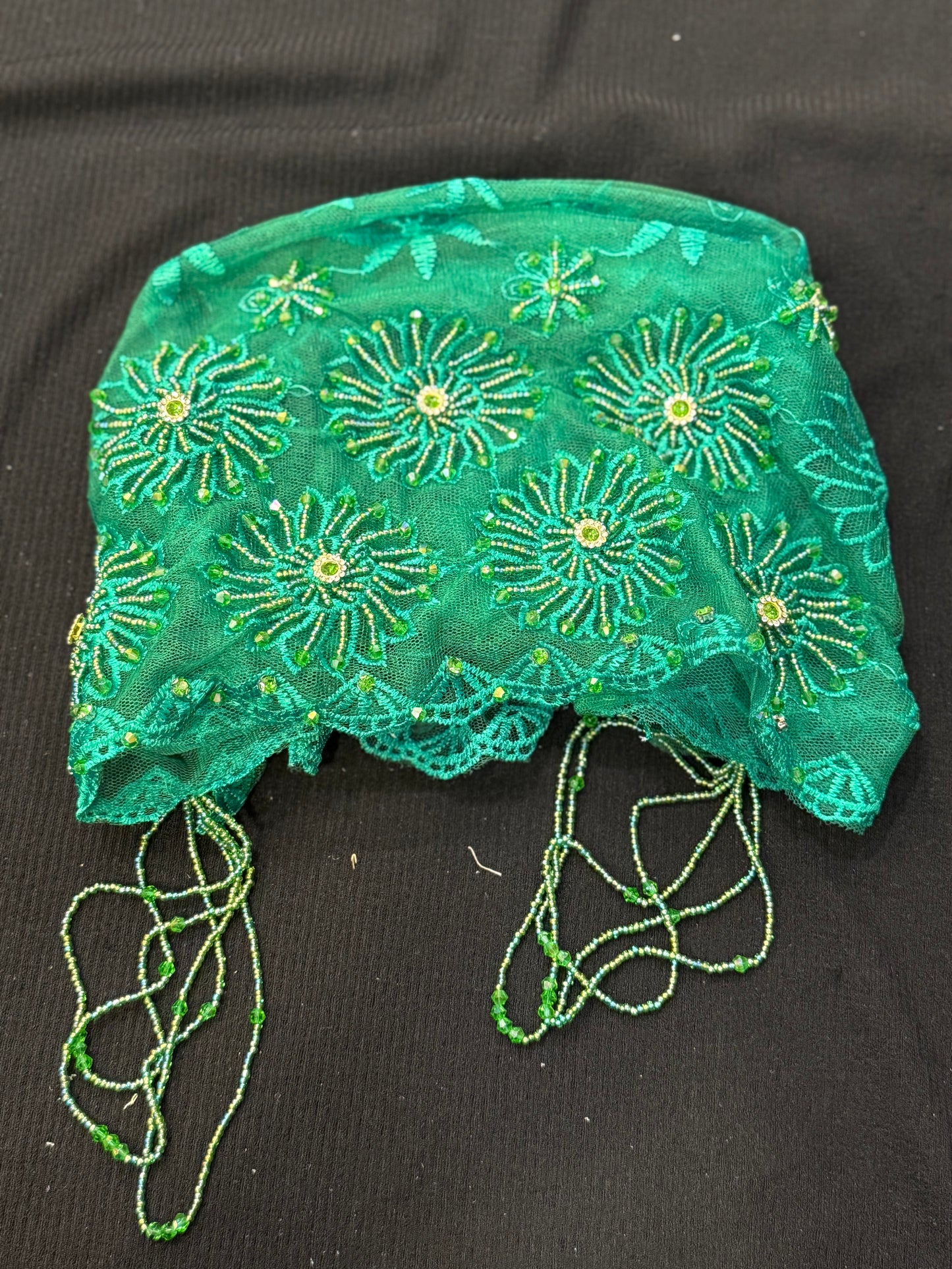 Green lace hijab cap flat lay with embellished floral pattern