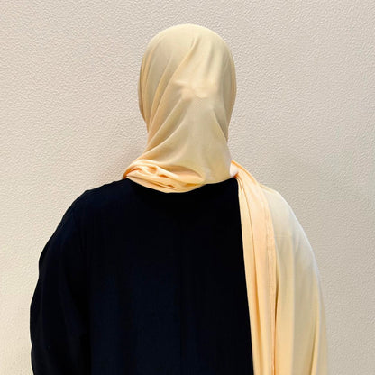 back view of beige jersey hijab highlighting lightweight texture, smooth finish, and full coverage styling.