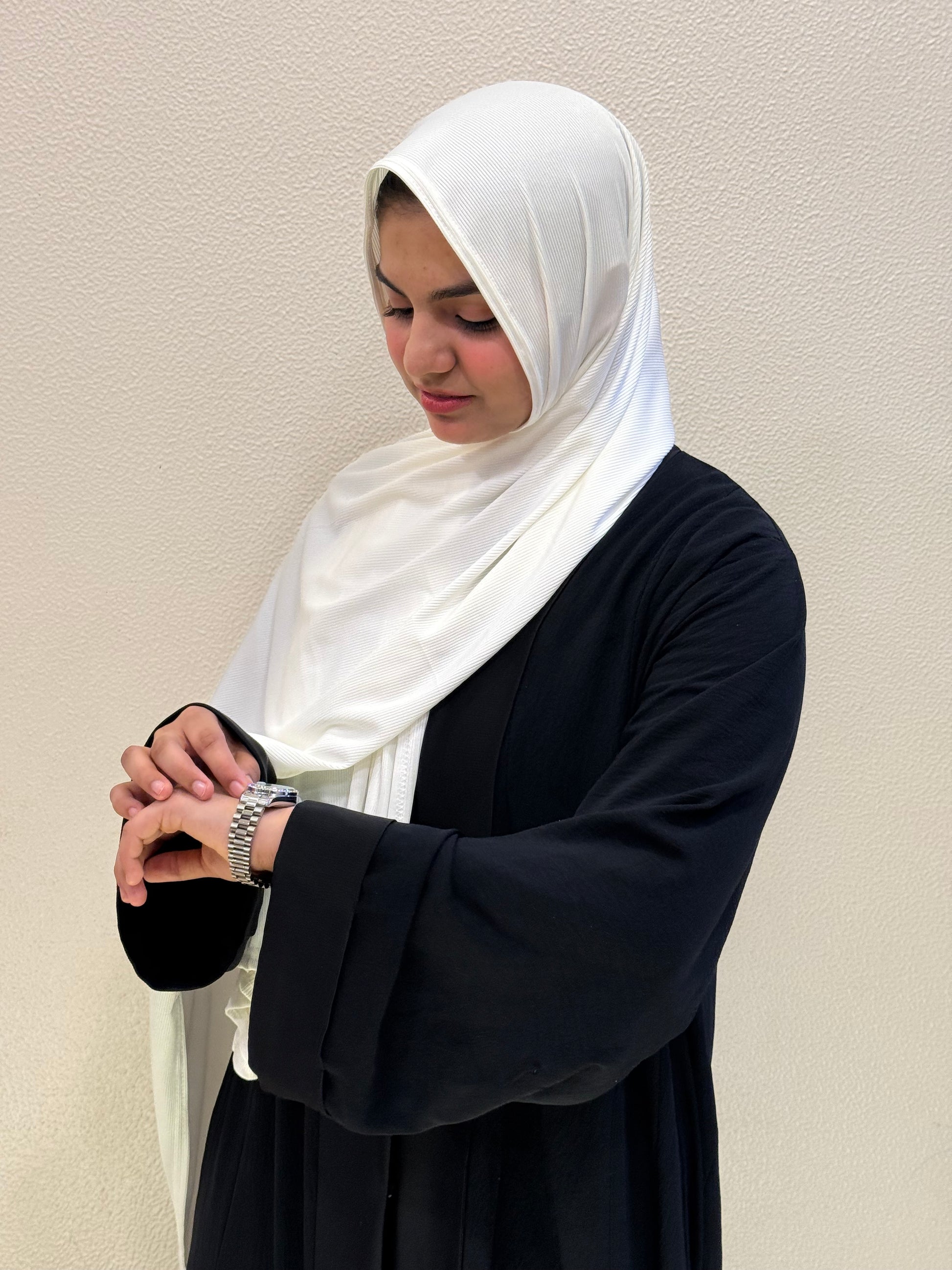 Premium jersey white hijab with soft ribbed texture, breathable fabric, and elegant drape for everyday modest fashion.