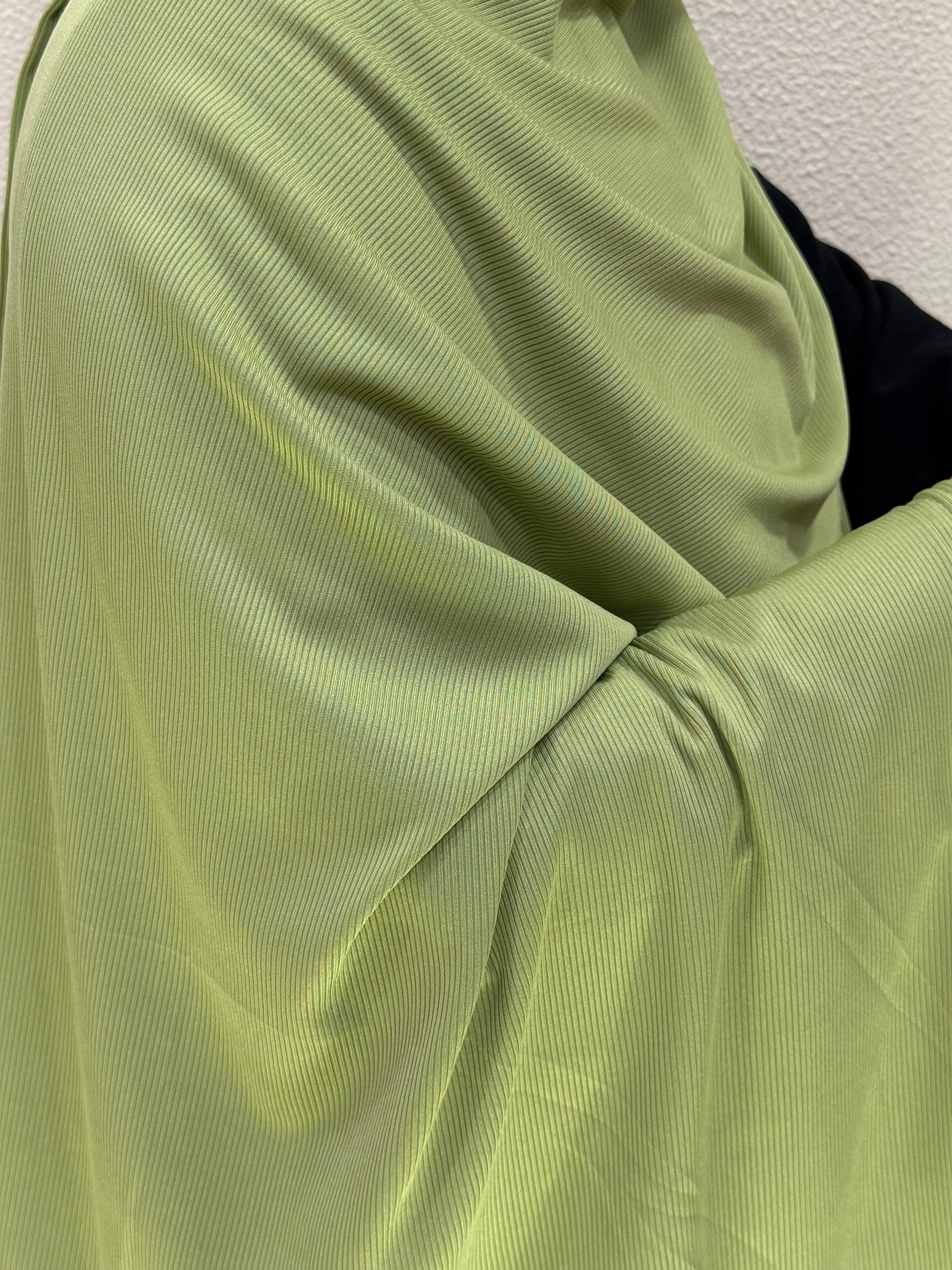 Smooth pastel green jersey hijab with premium material, fine ribbed detailing, and graceful flow for casual or formal outfits.