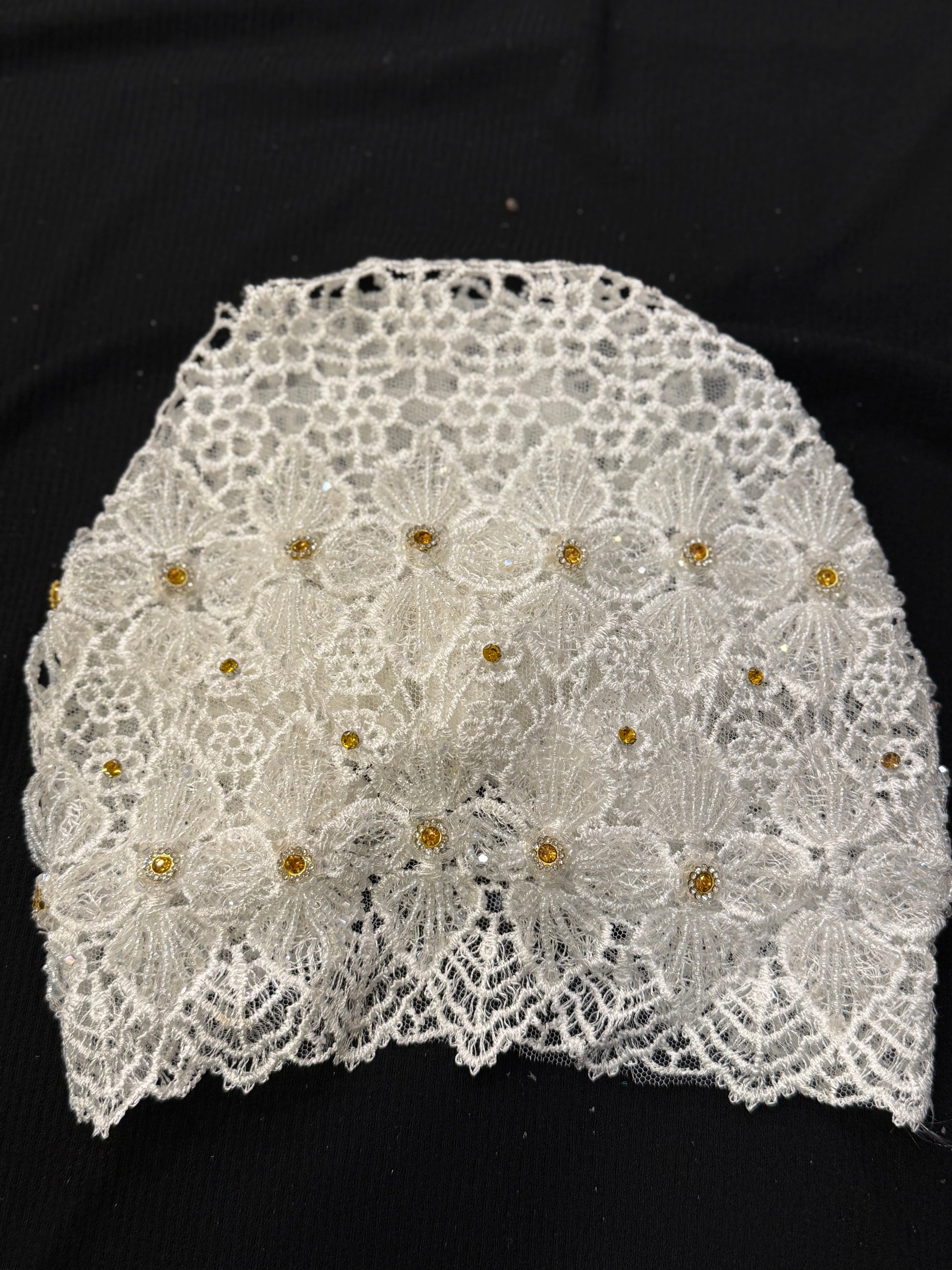White lace hijab cap flat lay with embellished floral pattern