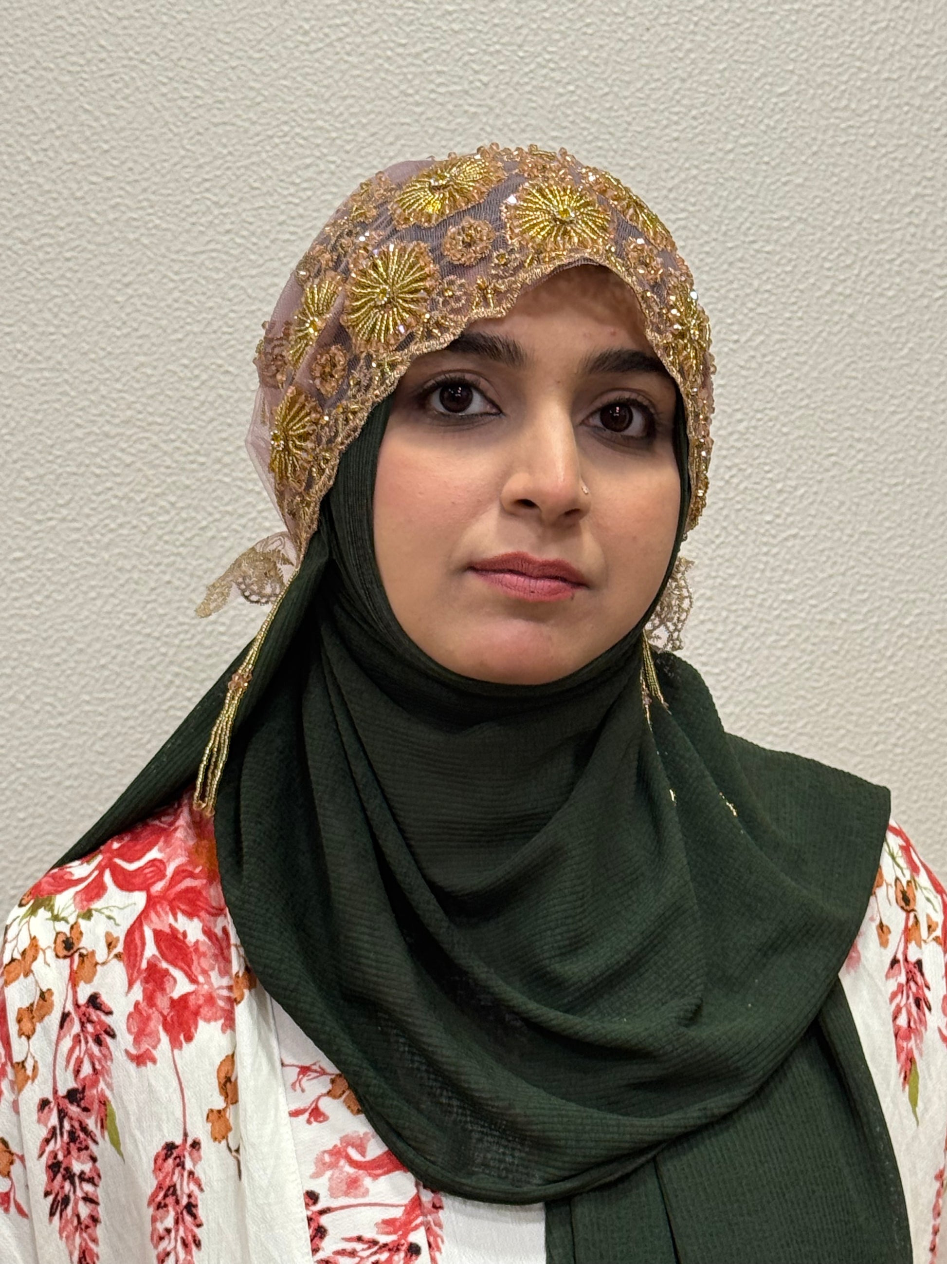 Pink and gold embroidered hijab cap front view with beadwork