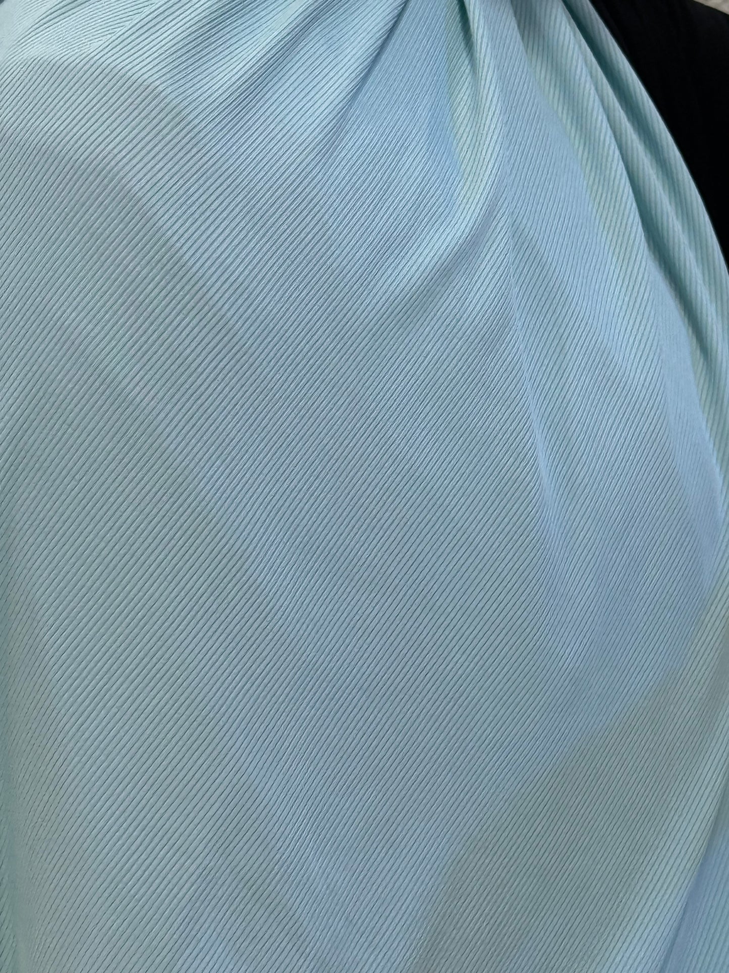 Close-up of light blue jersey hijab highlighting smooth premium material, fine ribbed detailing, and graceful flow.
