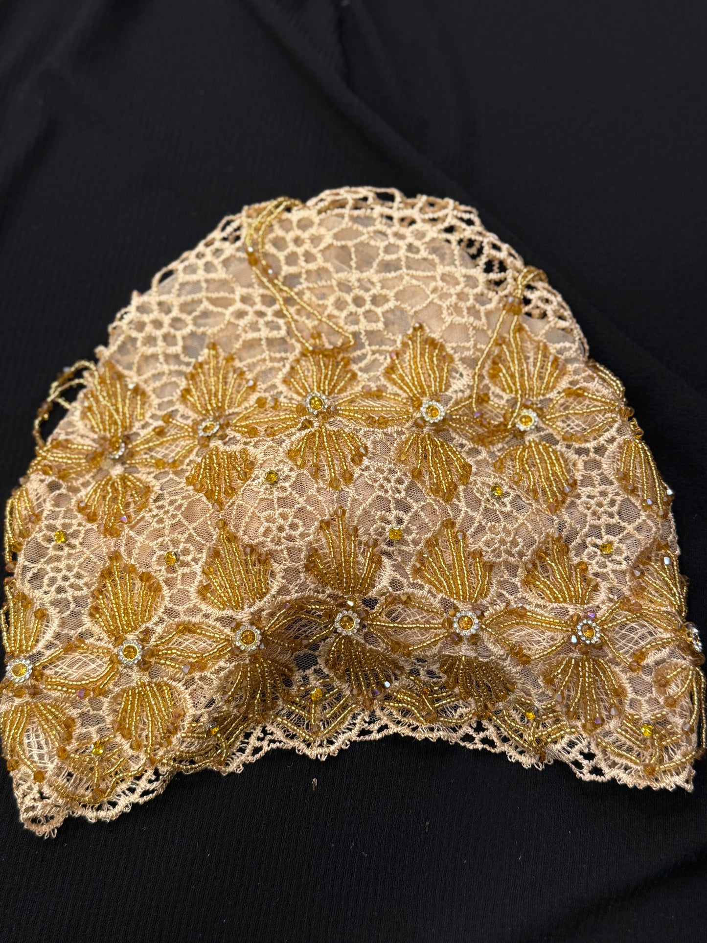 Brown and gold lace hijab cap flat lay with embellished floral pattern