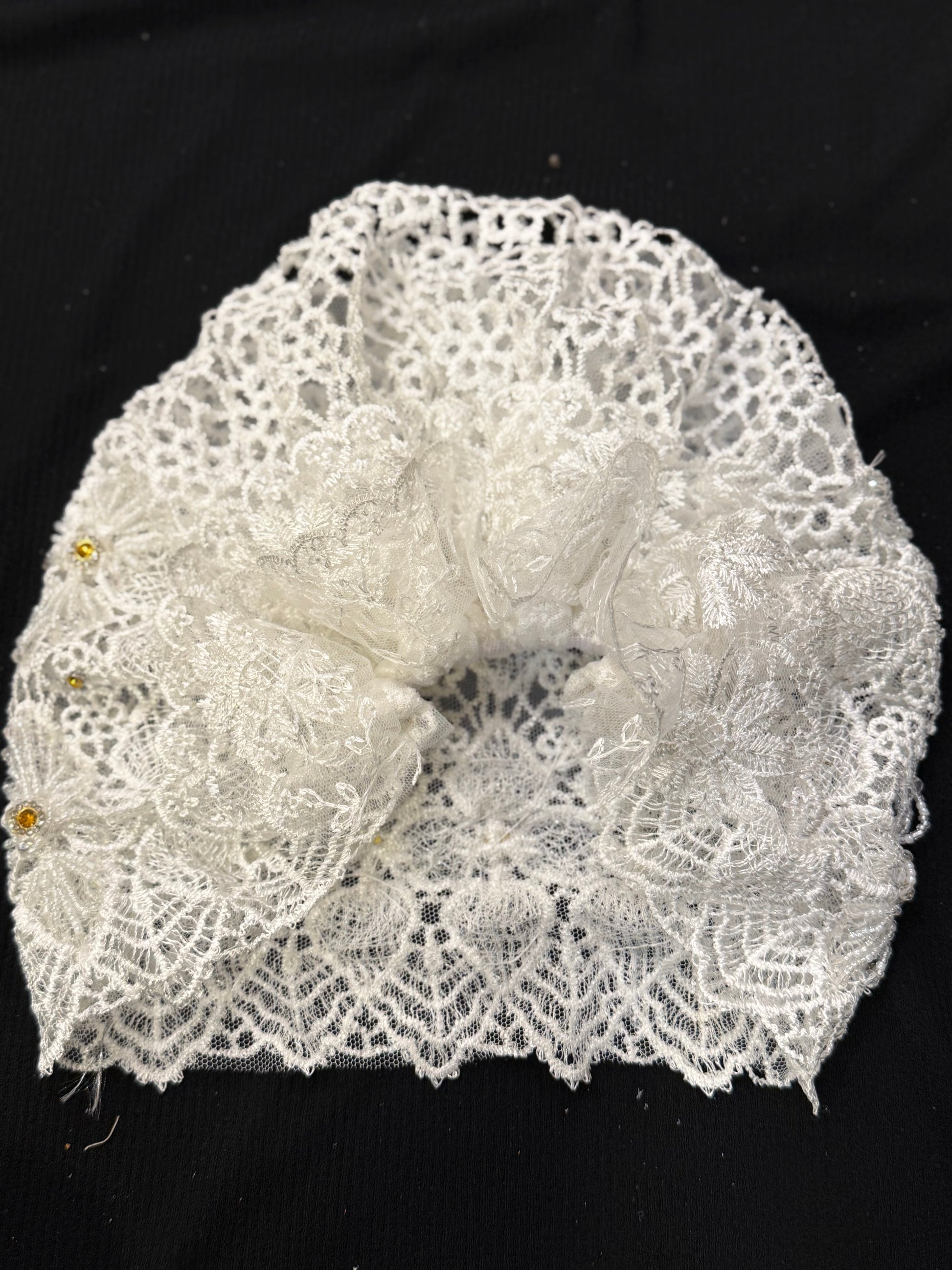White lace hijab cap top view with embellished floral pattern