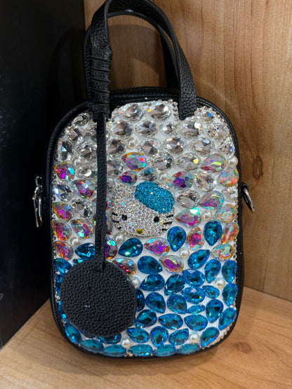 Front view of Black mini handbag with blue and silver crystal gem embellishment and cat face design