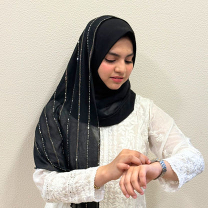Woman wearing black instant Turkish hijab with silver glitter stripe